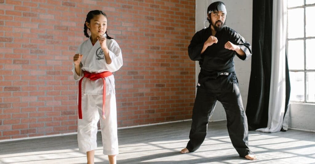 Child practicing guard stance with instructor for confidence building